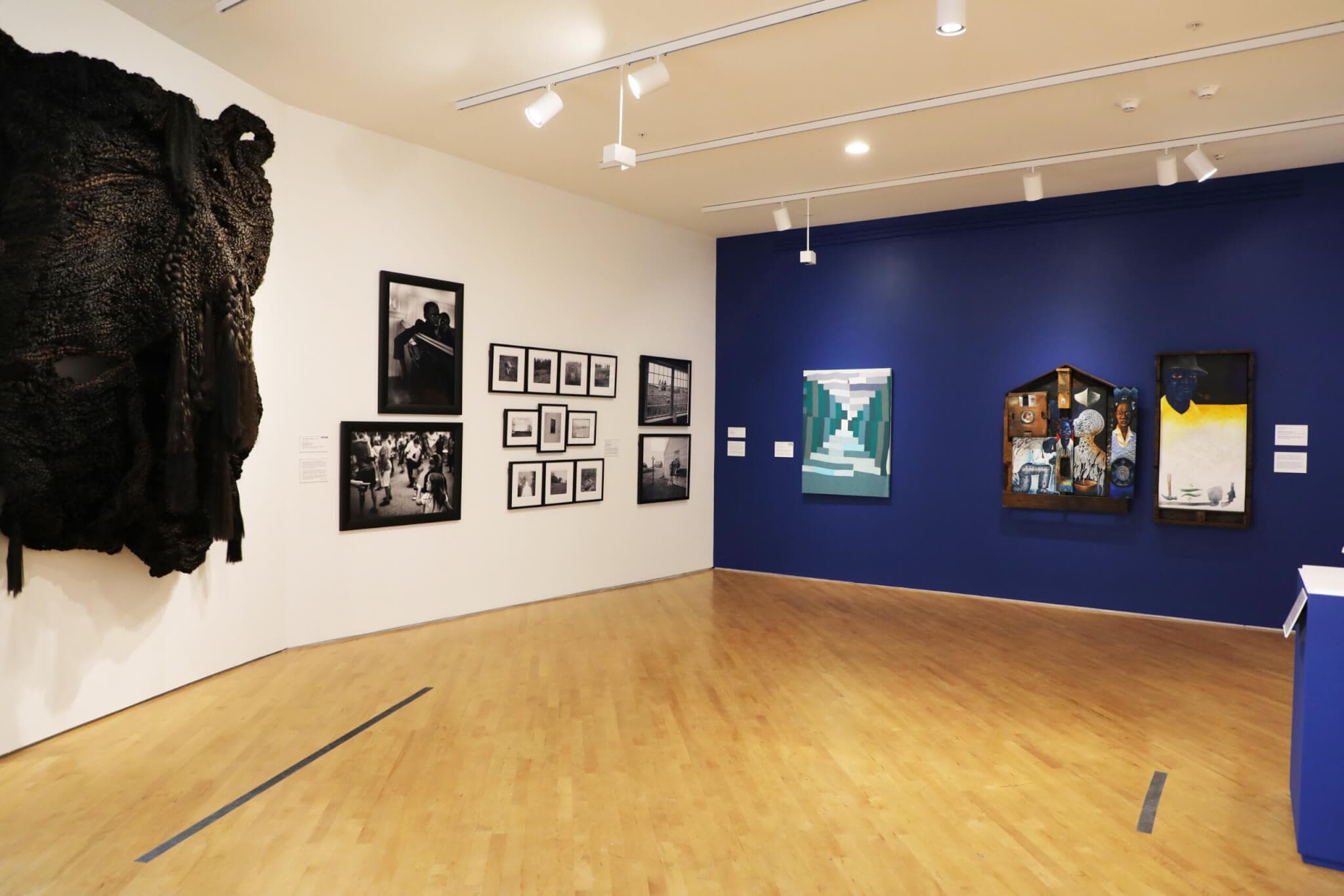 Installation view of hanging artworks in a gallery.